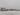 Загородный дом в Подмосковье, зимний пейзаж с покрытым снегом участком и жилыми постройками в коттеджном поселке.